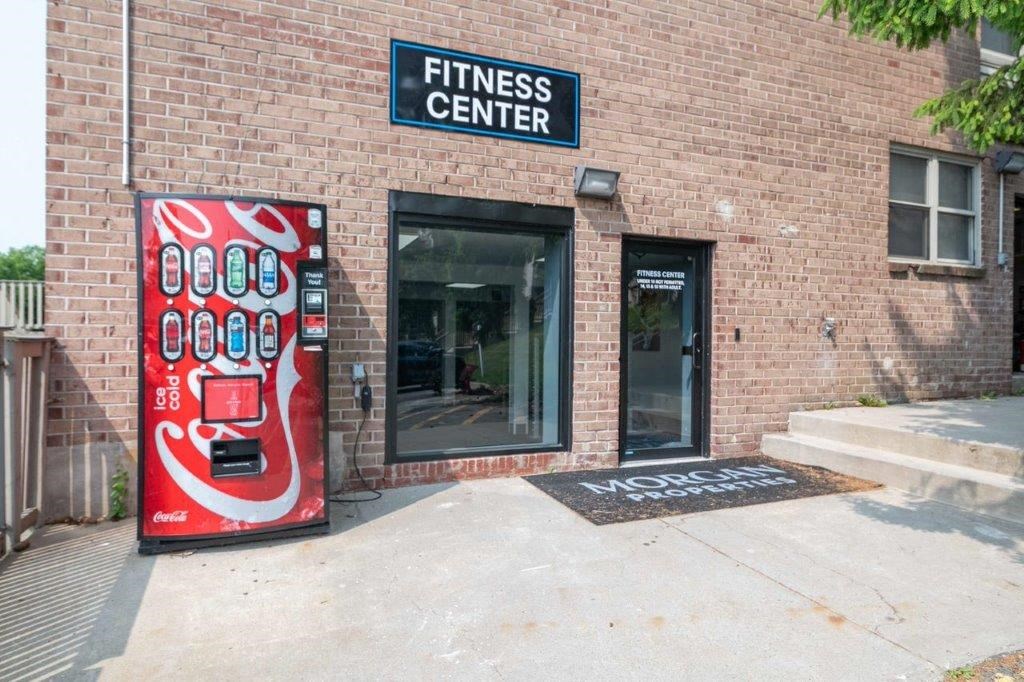 a coca cola vending machine outside of a fitness center