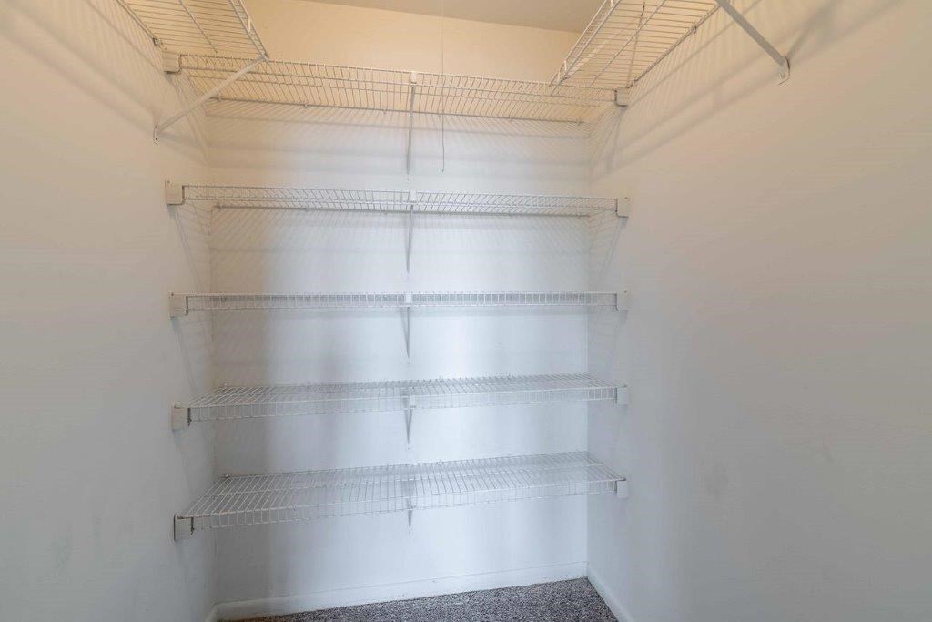 a empty closet with empty shelves in a white room