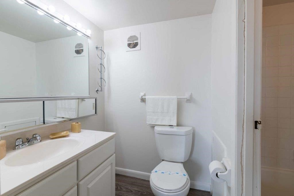 a bathroom with a toilet and a sink and a mirror
