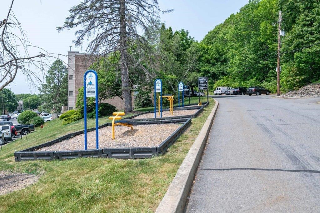 a park with playground equipment on the side of a street