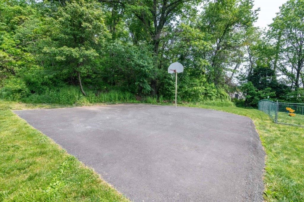 a basketball court with a hoop in the middle of it