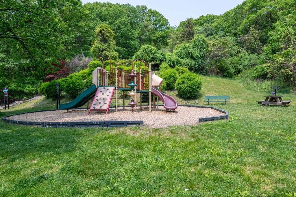a playground with slides and other toys in a park