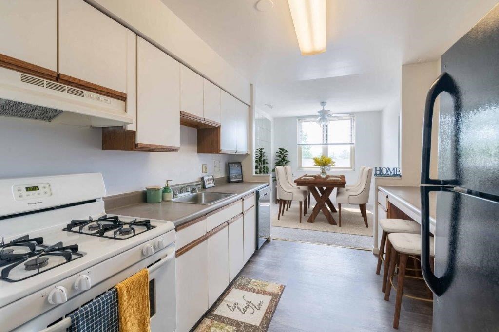 a kitchen with a stove and a refrigerator and a table