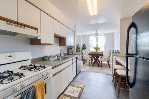 a kitchen with a stove and a refrigerator and a table