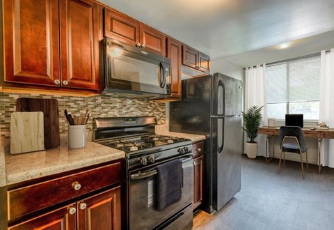 a kitchen with stainless steel appliances and wooden cabinets