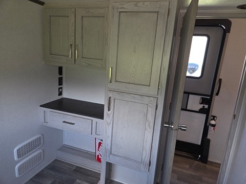 A kitchen area with a counter and cabinets.