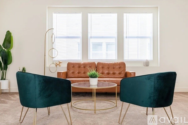 A living room with a green chair, a brown sofa, and a coffee table.