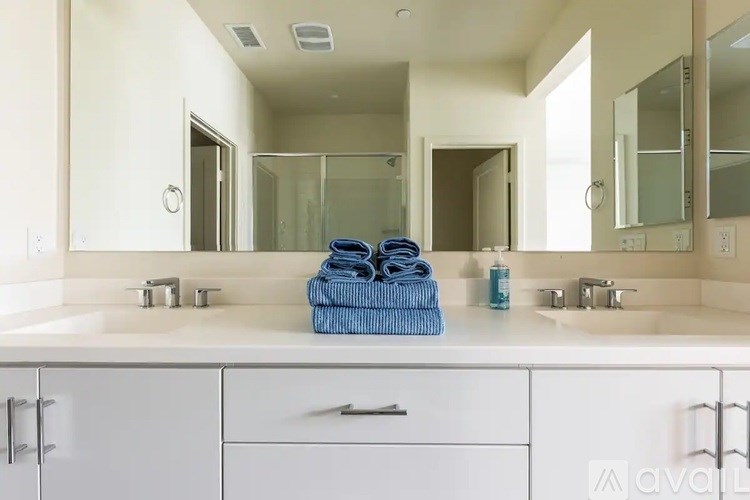 A bathroom with two sinks and a large mirror.