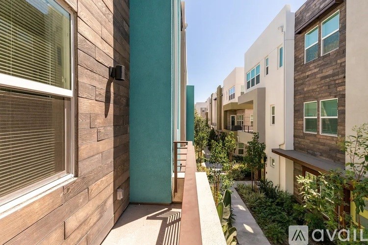 A modern building with a wooden exterior and a balcony.
