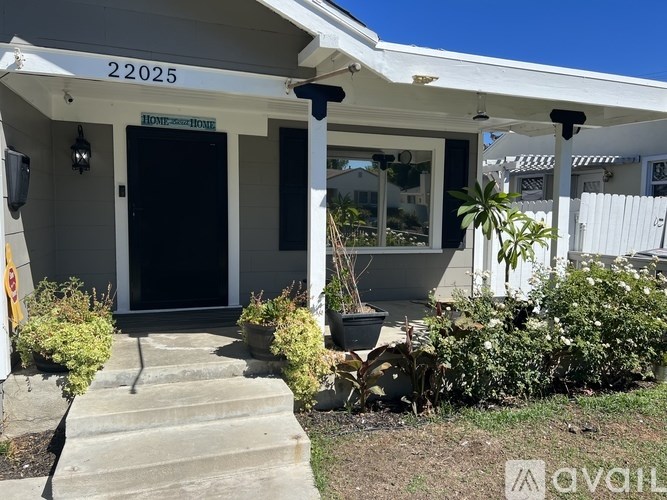 A house with the number 22025 on the front door.