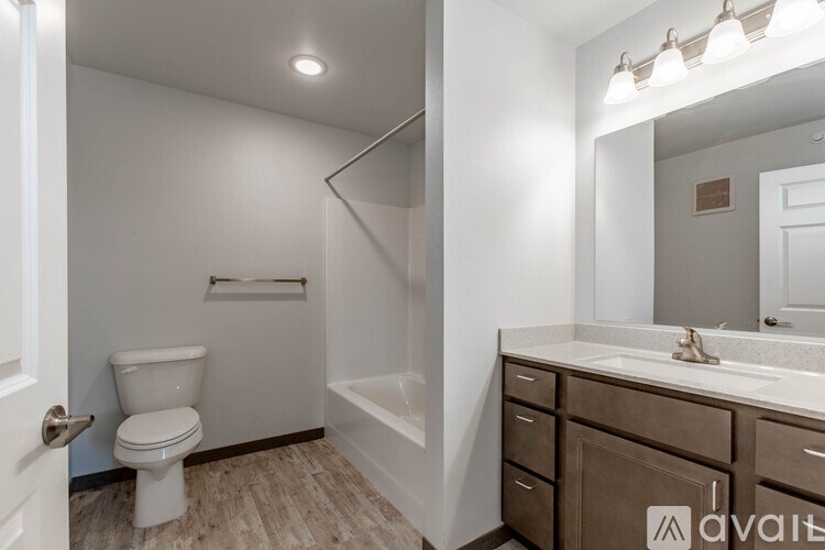 A bathroom with a toilet, sink, and bathtub.