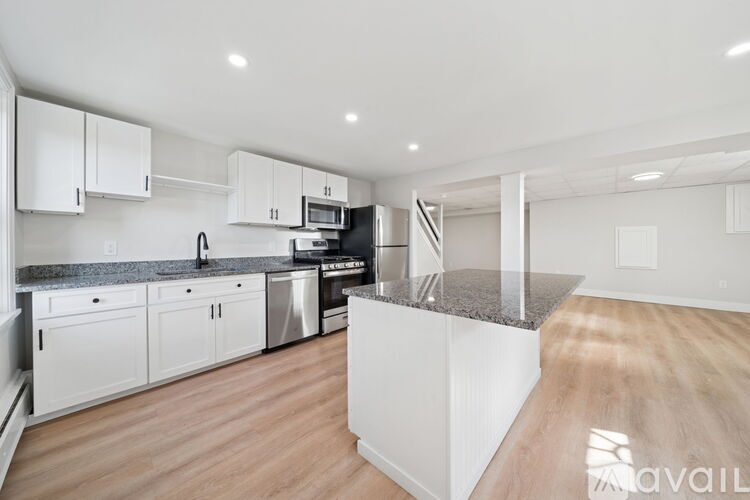 A kitchen with a dining table and chairs.