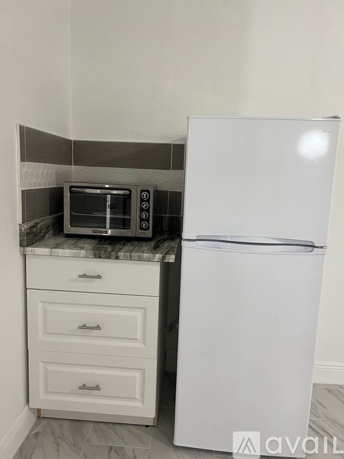 A white fridge and microwave in a kitchen.
