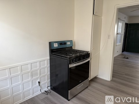 A black oven with a digital display is installed in a kitchen.
