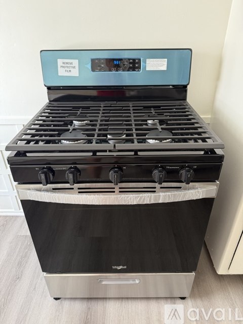 A stove top with a digital display and control knobs.