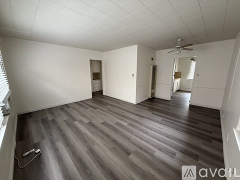 A room with a white wall and a ladder.