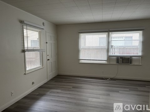 A room with a ladder and a white wall.