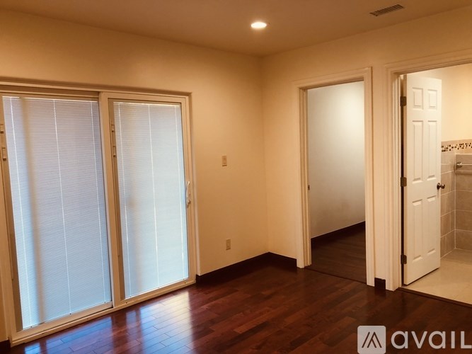 A room with a sliding door and a white door.