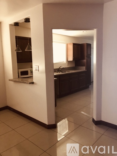 A kitchen with a microwave and a sink.