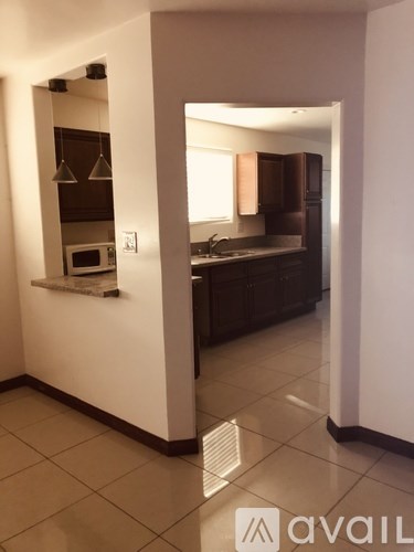 A kitchen with a microwave and a sink.