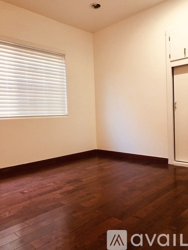 A room with wooden floors and a white door.