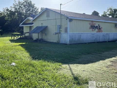 A white building with a sign that says "raye's" on it.
