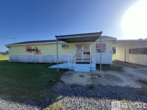 A yellow building with a sign that says "Raye's" on it.