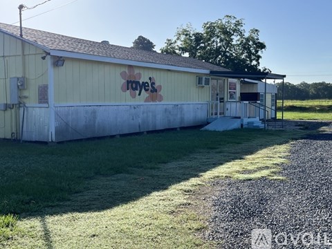 A yellow building with a sign that says "Raye's" on it.