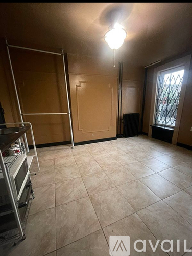 A room with a ceiling fan and sliding glass doors.