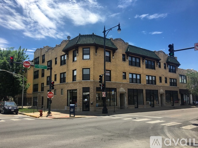 A street view of a building with a green roof and a traffic light.