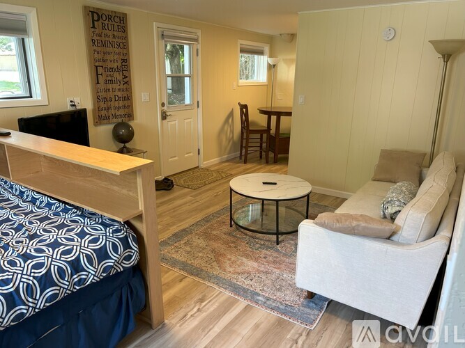 A bedroom with a bed, a couch, and a coffee table.