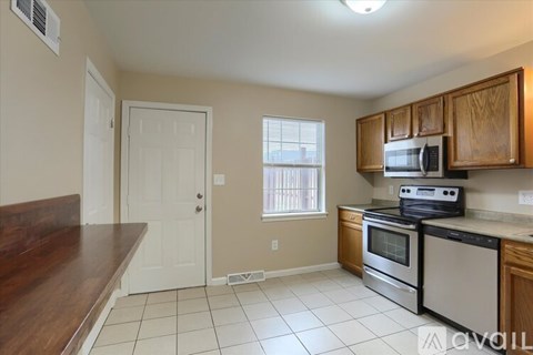 A kitchen with a stove top oven and microwave.