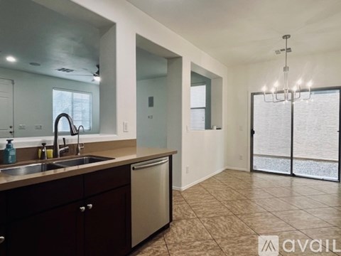 A kitchen with dark brown cabinets and a light brown countertop.