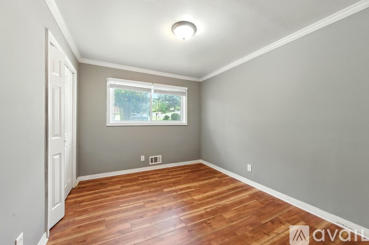 A room with wooden floors and a window.