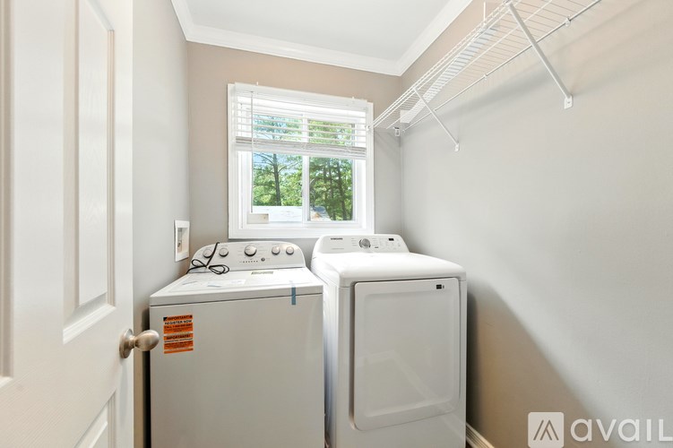A small laundry room with a washer and dryer.