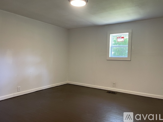 A room with a window showing a green outdoor area.