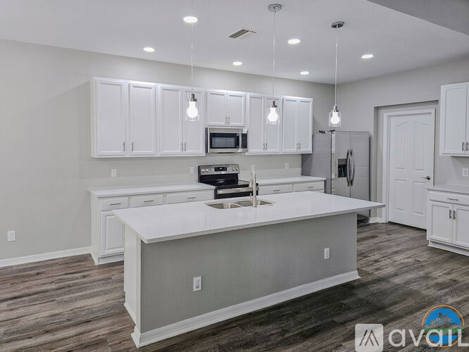 A modern kitchen with white cabinets and a central island.