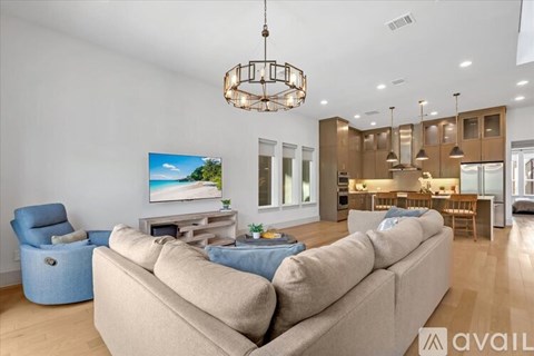 A modern living room with a large sofa and a television.