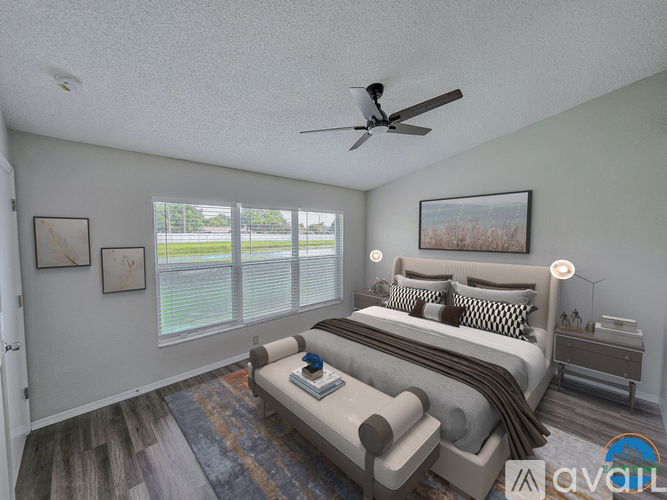A bedroom with a large bed and a ceiling fan.