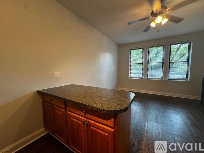 A room with a counter and a ceiling fan.