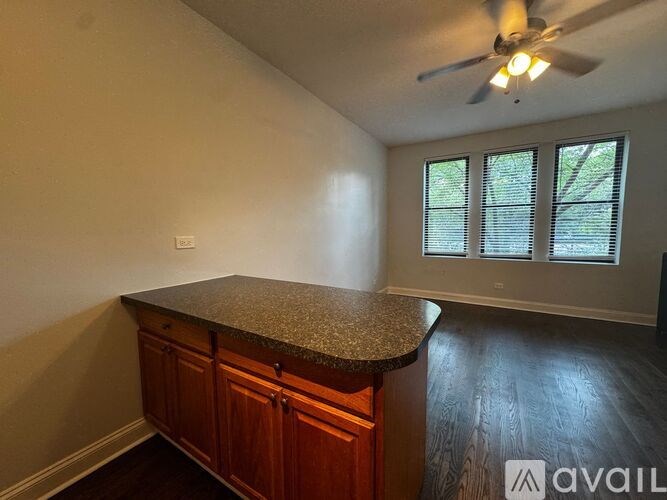 A room with a counter and a ceiling fan.
