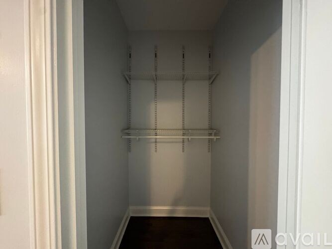 A white hallway with a door on the left and a door on the right.