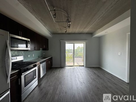 A kitchen with dark brown cabinets and a white counter.