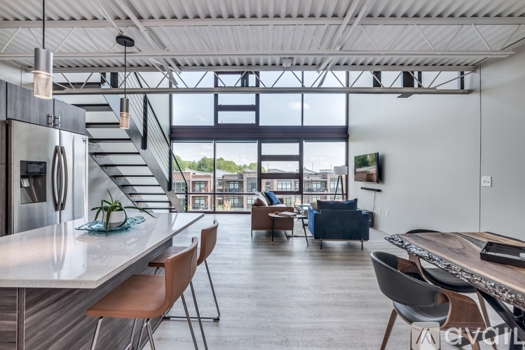 A modern kitchen with a dining table and chairs.