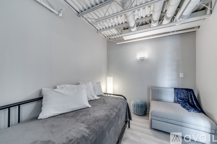 A bedroom with a bed and a bench.