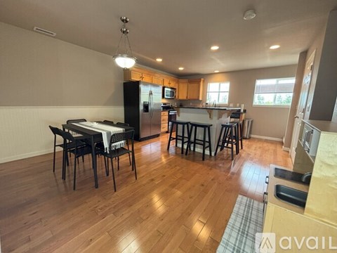 A kitchen with a table and chairs in the middle of the room.
