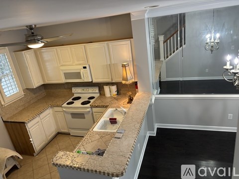 A kitchen with a stove top oven and microwave built into the cabinetry.