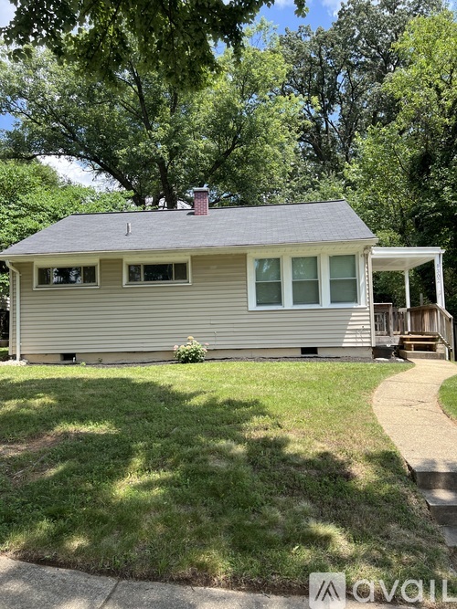 A house with a grey roof and a white porch.