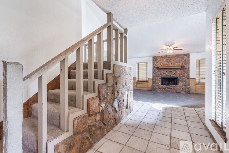A stone staircase leads to a living room with a fireplace.