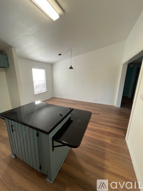 A room with a desk and a window.